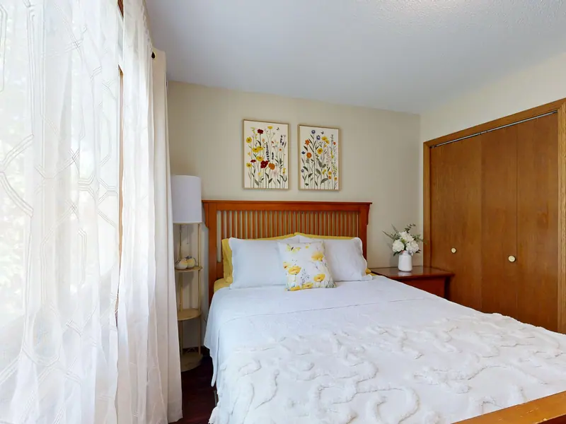 Bright bedroom with floral decor and wooden elements. Perfect for home decor inspiration.