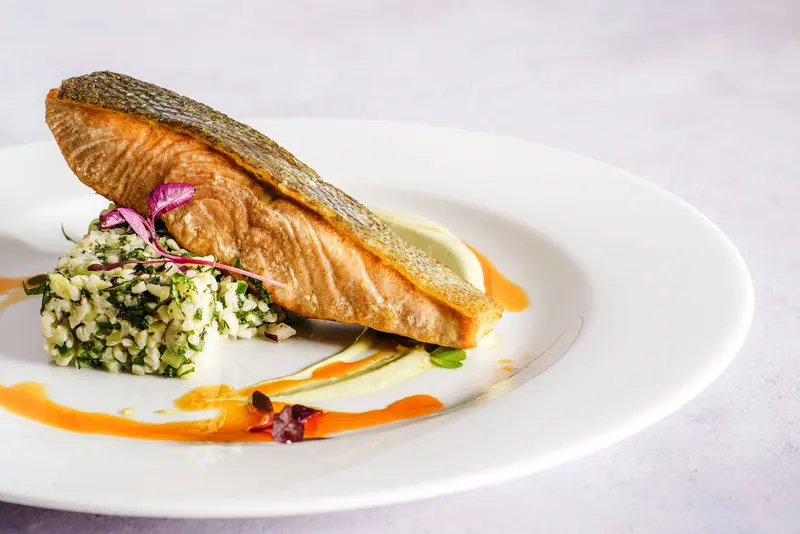 Crisp-skinned salmon on a white plate