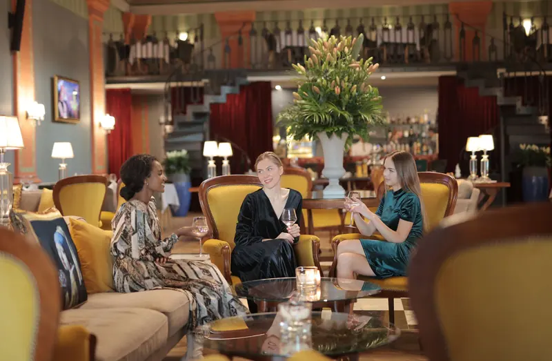 Friends visiting in the Grand Salon
