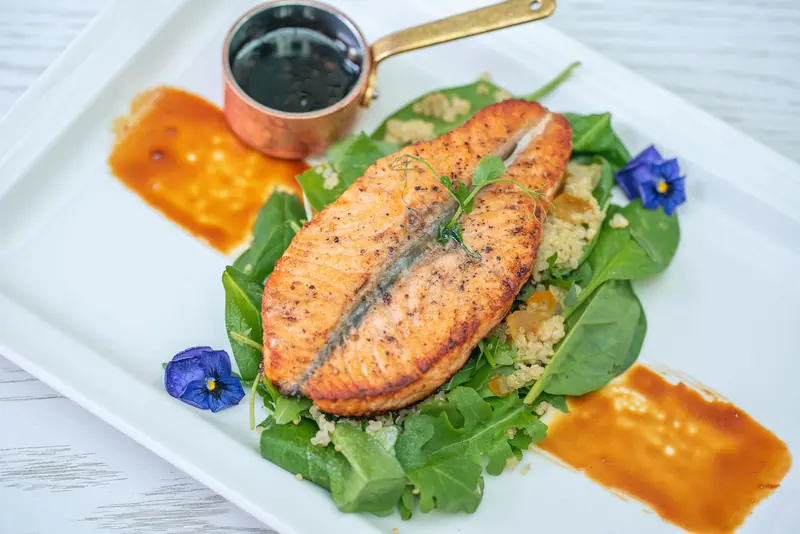 Seared salmon on a bed of greens