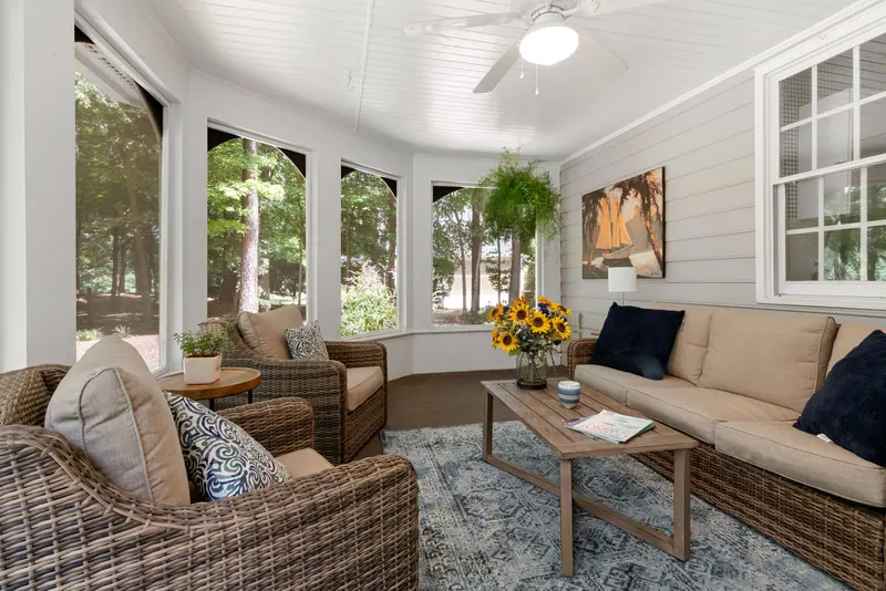 The sunroom with its wicker sofas