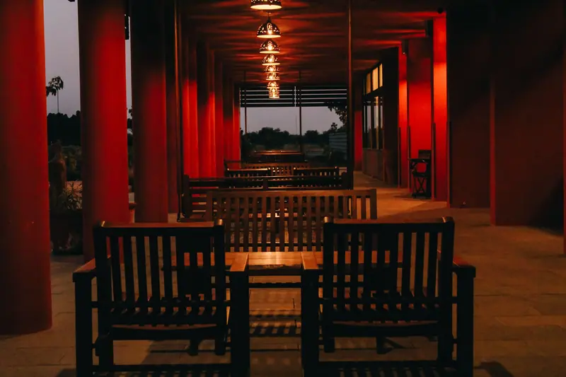 The long porch with its red columns after dark