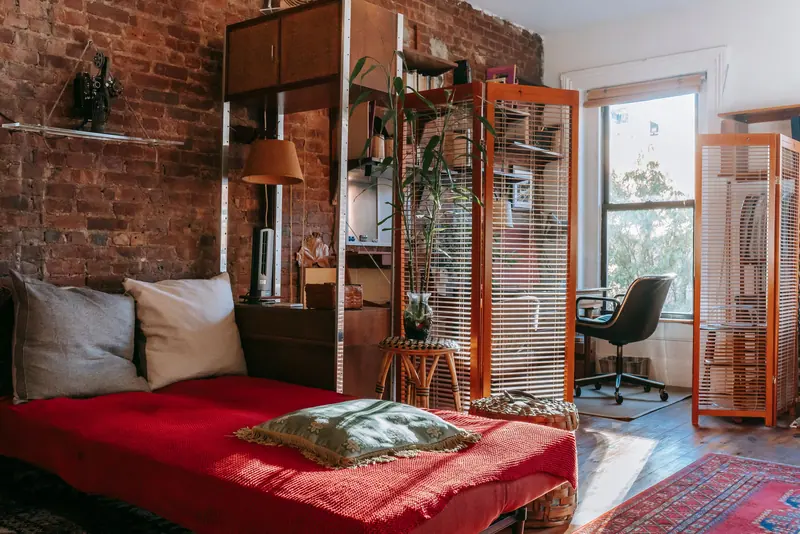A sunny loft corner with a reading bed and plants