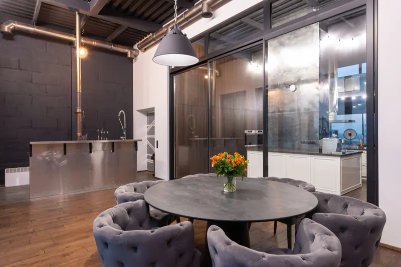 The Pour Room dining area set under the old steel trusses