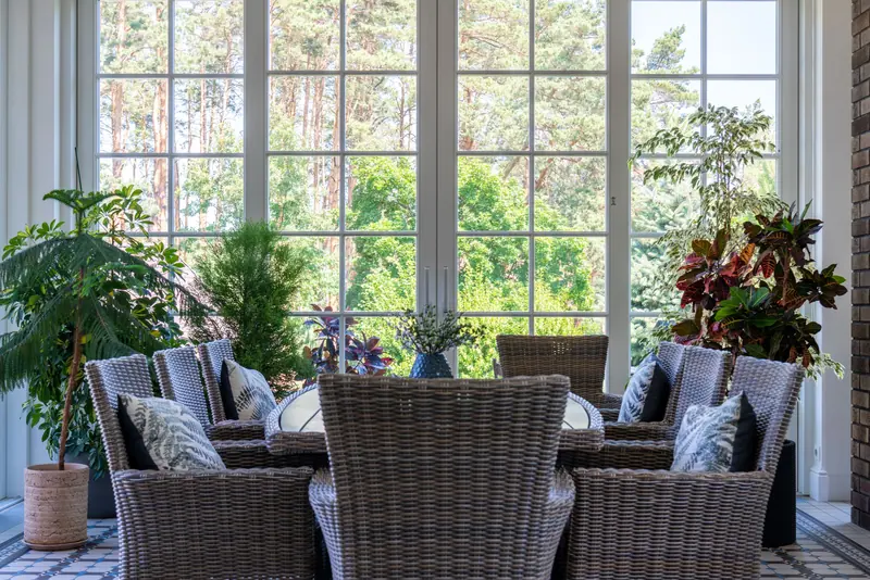 Wicker chairs around the sunroom table