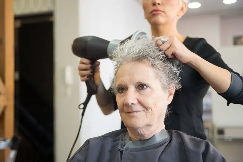 A resident getting a blow-dry in the salon