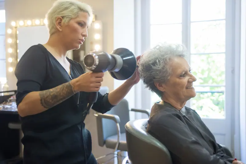 A resident getting a blow-dry in the first-floor salon