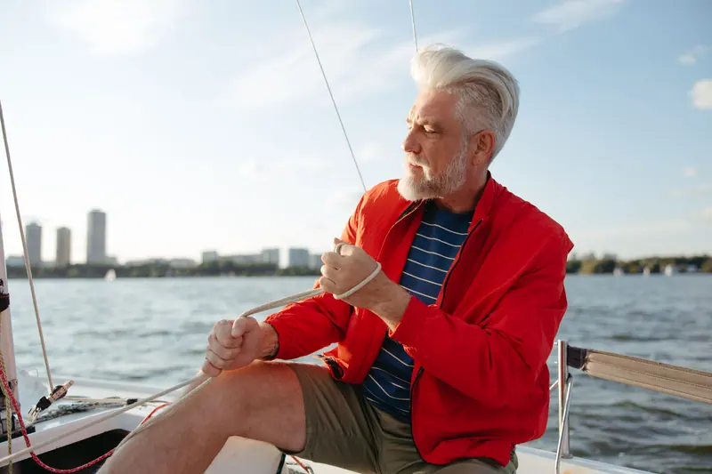 A resident at the helm of his sailboat