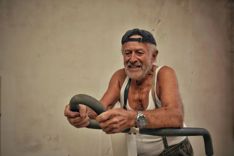 A resident grinning through his workout on the strength machine