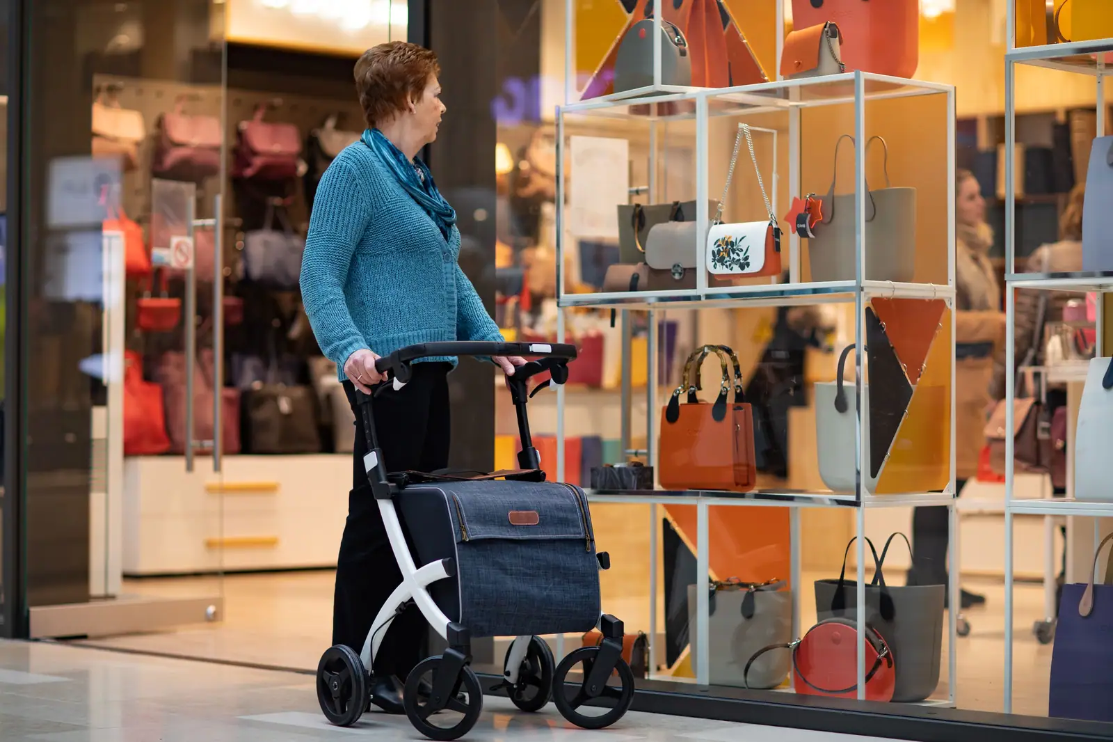 A former patient shopping with her rollator