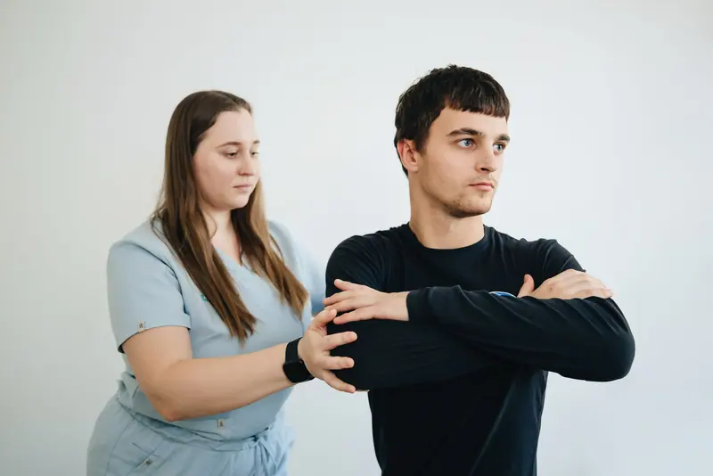 A patient lifting a light weight during shoulder therapy