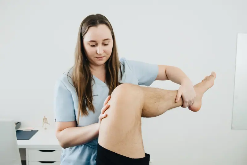 A therapist working on a guest's shoulder strength