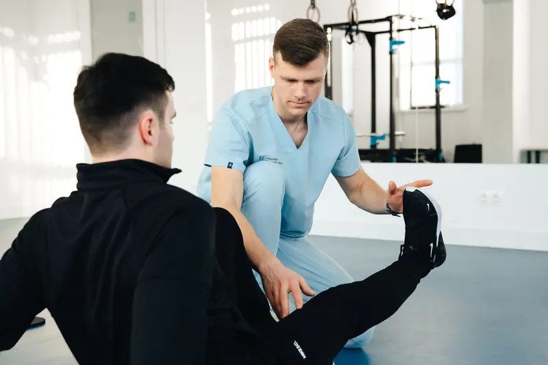 A guest doing assisted stretches on the table