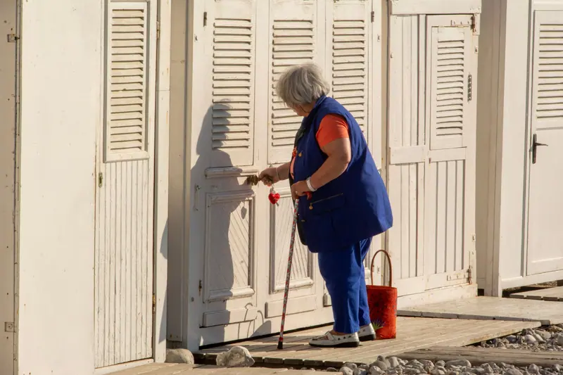 A resident with her walker in the sunny doorway