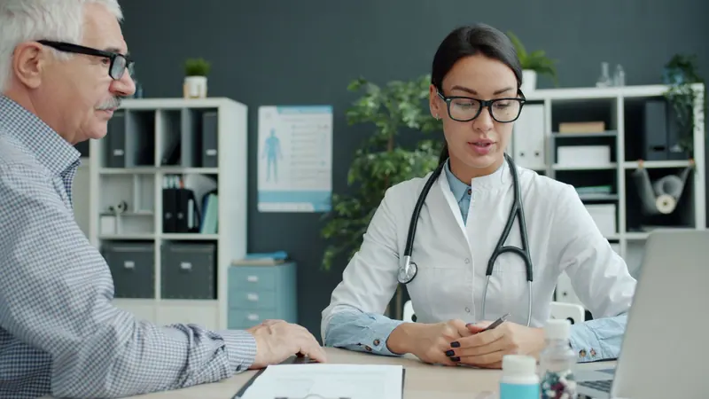 A patient going over his recovery plan with the doctor