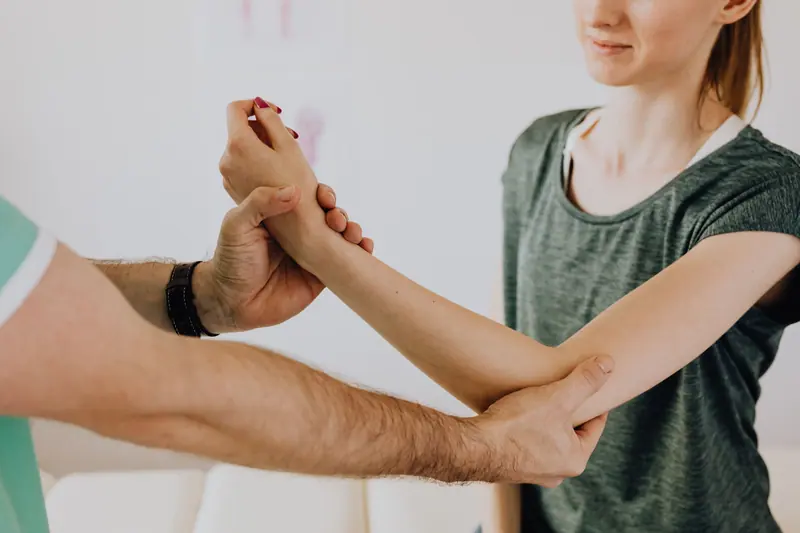 A therapist moving a guest's elbow