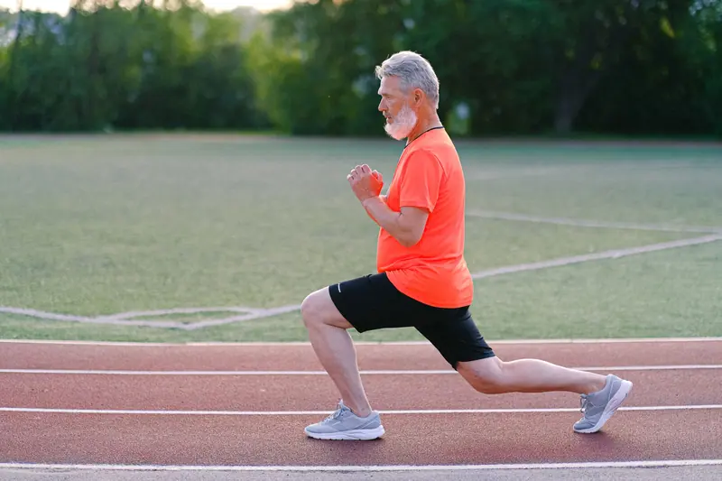 A resident doing lunges on the track