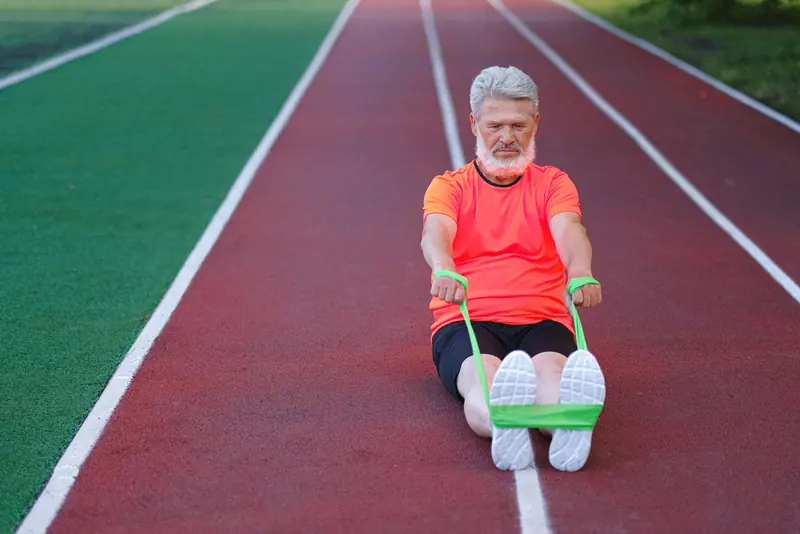 A guest doing seated band rows on the track