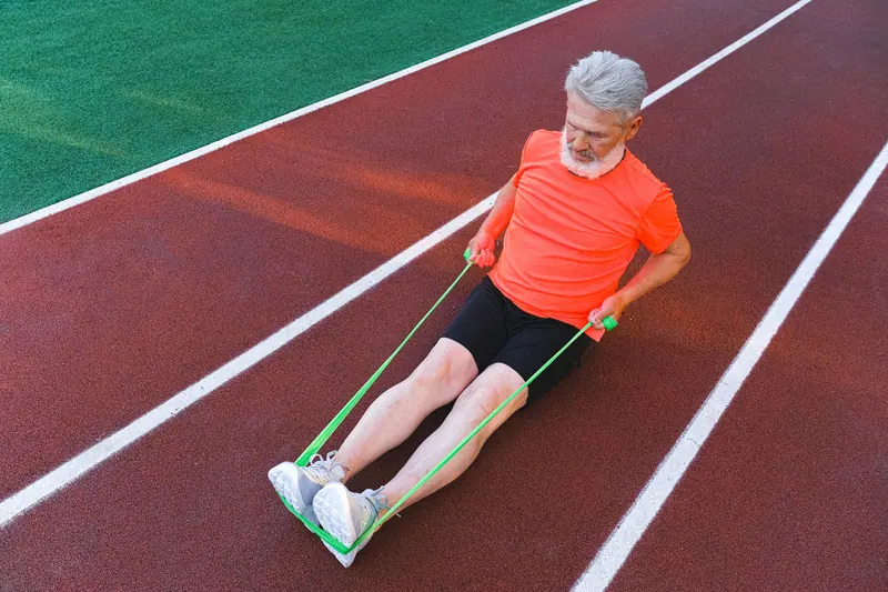 A former patient doing band exercises on the track
