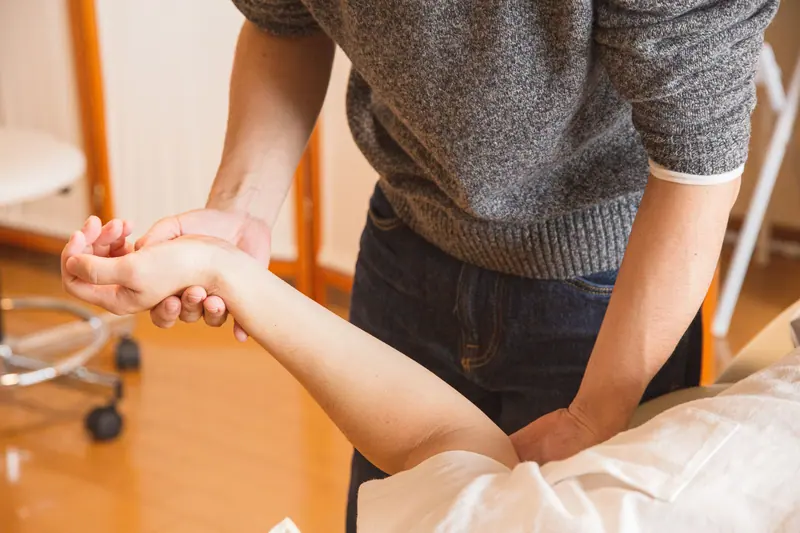A therapist working on wrist mobility