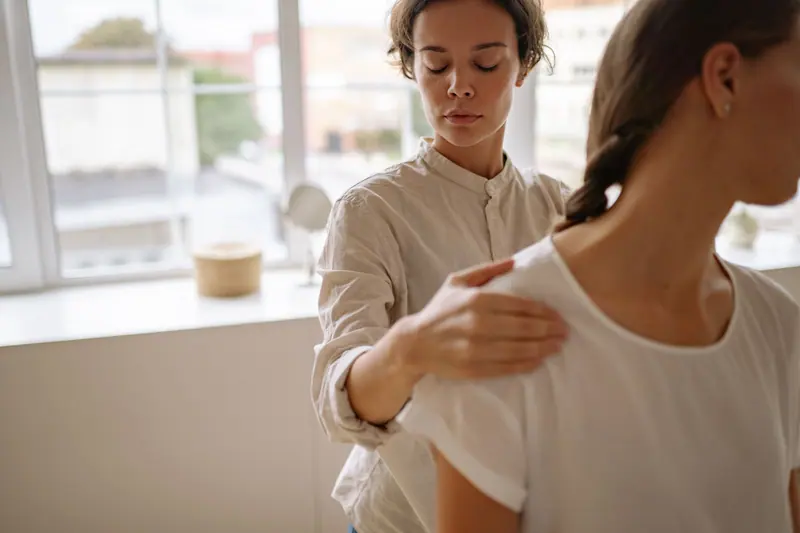 A therapist working on a guest's shoulder
