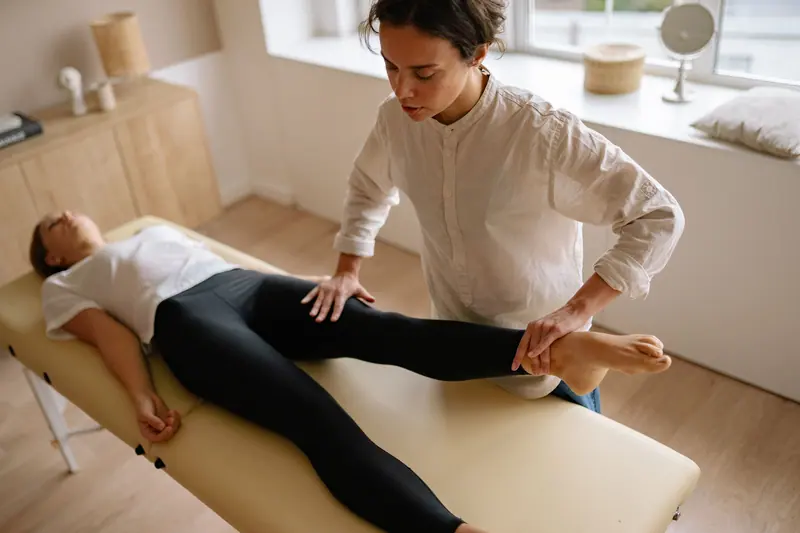 A therapist working on a guest's hip mobility