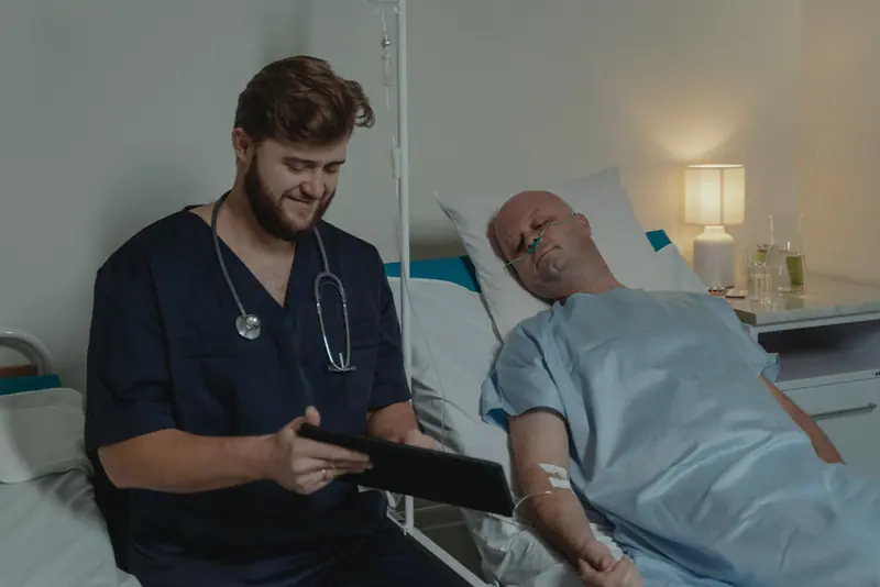 A nurse reviewing a chart with a resident