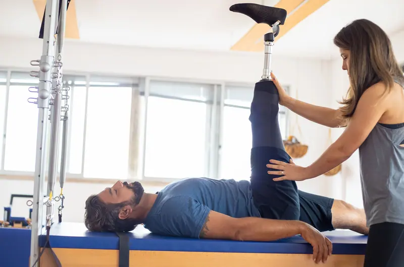 A therapist supporting a guest's leg stretch