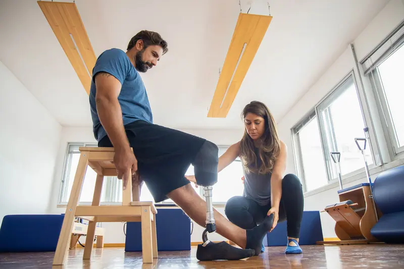A patient with a prosthesis practicing step-ups