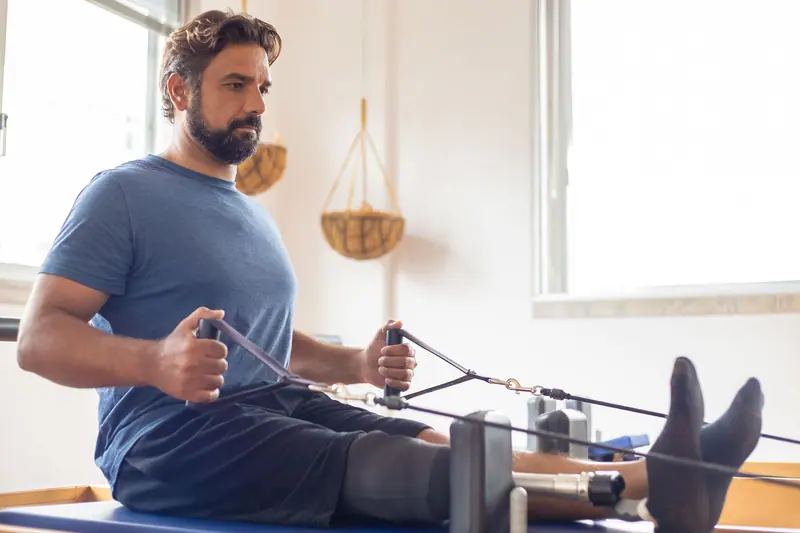 A patient working with resistance bands in the therapy gym