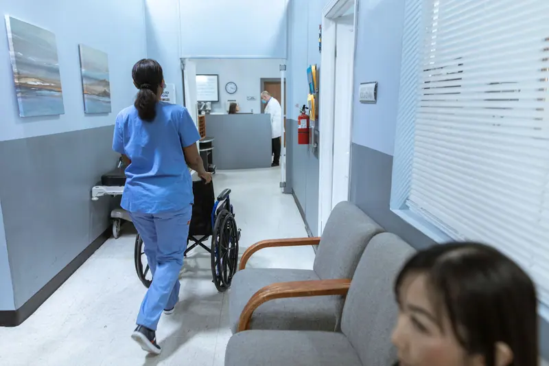 A nurse heading down the rehab hall