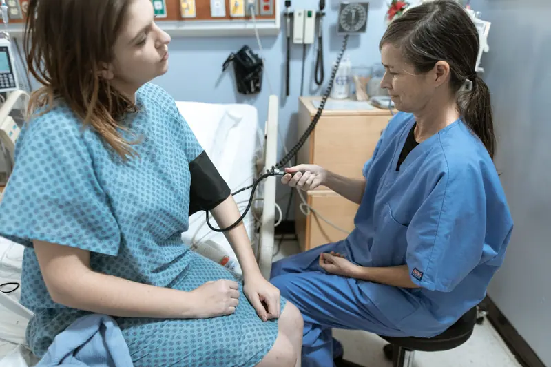 A nurse taking a guest's blood pressure