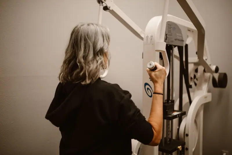 A patient working on upper-body strength at the pulldown machine