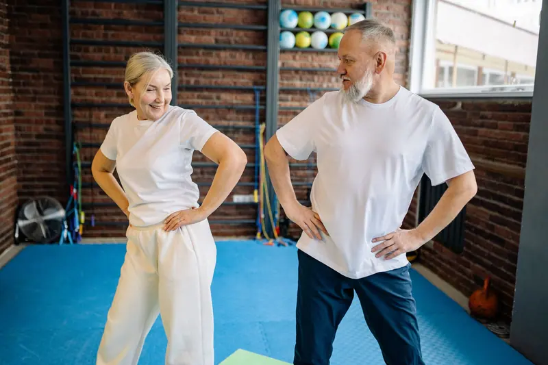 Two patients warming up before a gym session