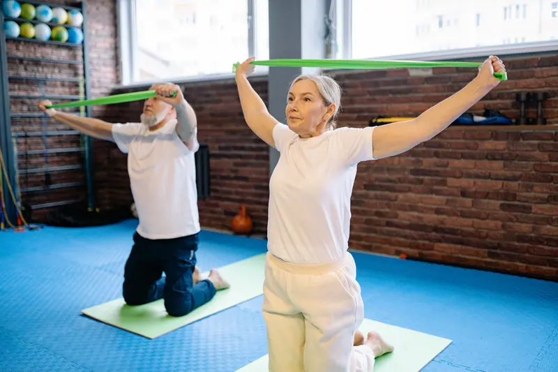 Patients stretching resistance bands overhead