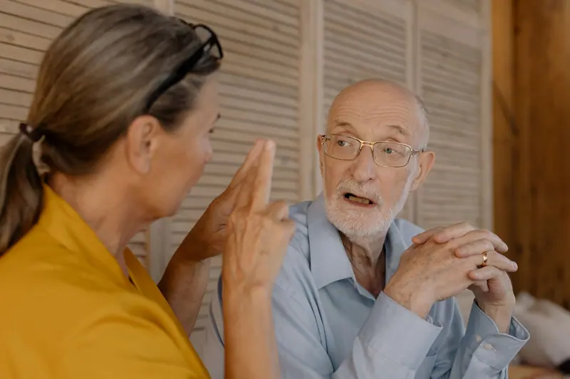 A therapist listening as an older man describes his goals for recovery