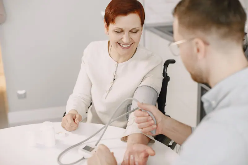 A nurse checking blood pressure