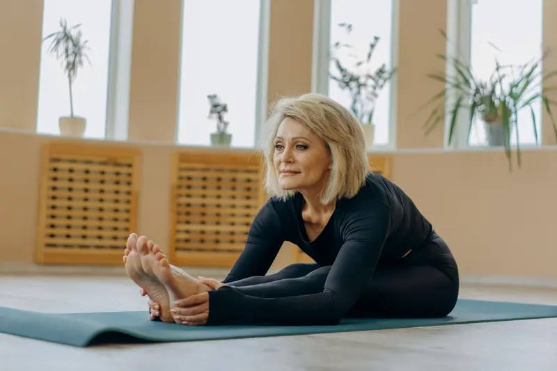 A patient stretching on a mat