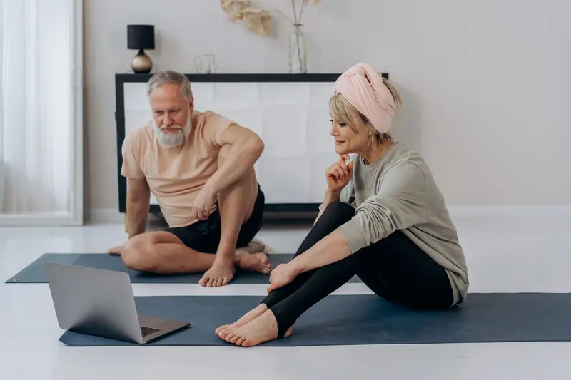 A couple doing their home exercises together by video