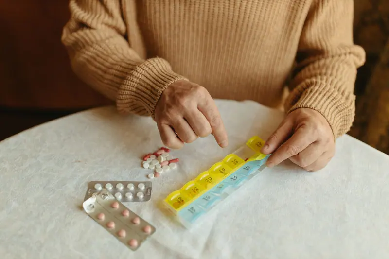 A patient setting up her weekly pill organizer before going home