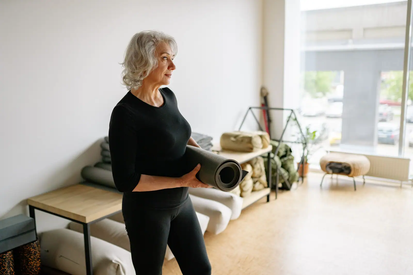 A patient carrying her yoga mat
