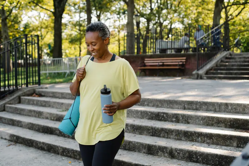 A rehab graduate heading out for a walk with her water bottle