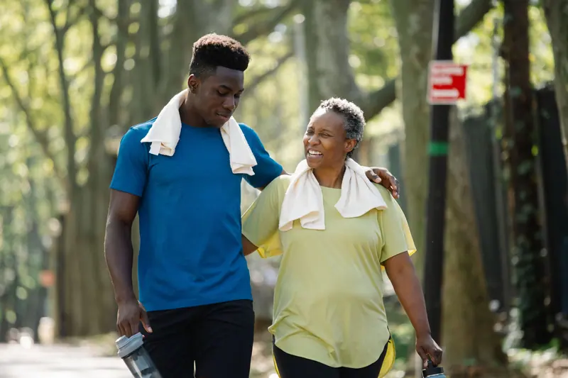 A mother and son walking together after a morning workout