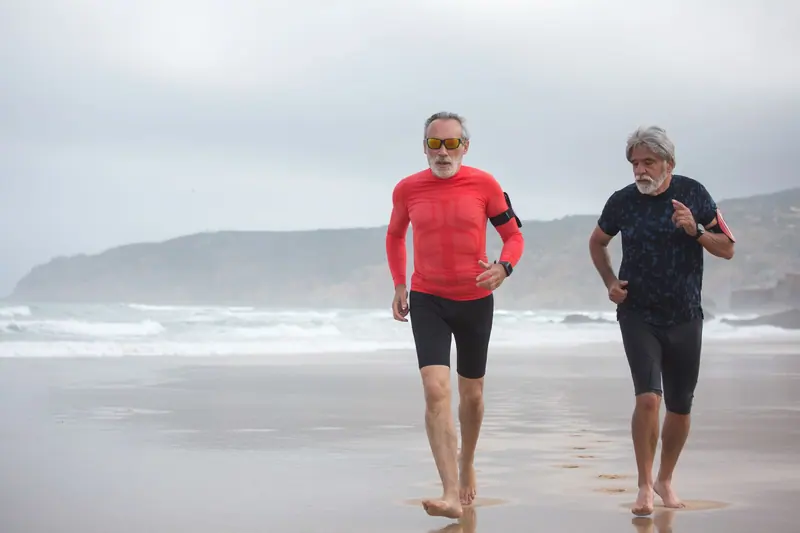 Two former patients jogging on the beach