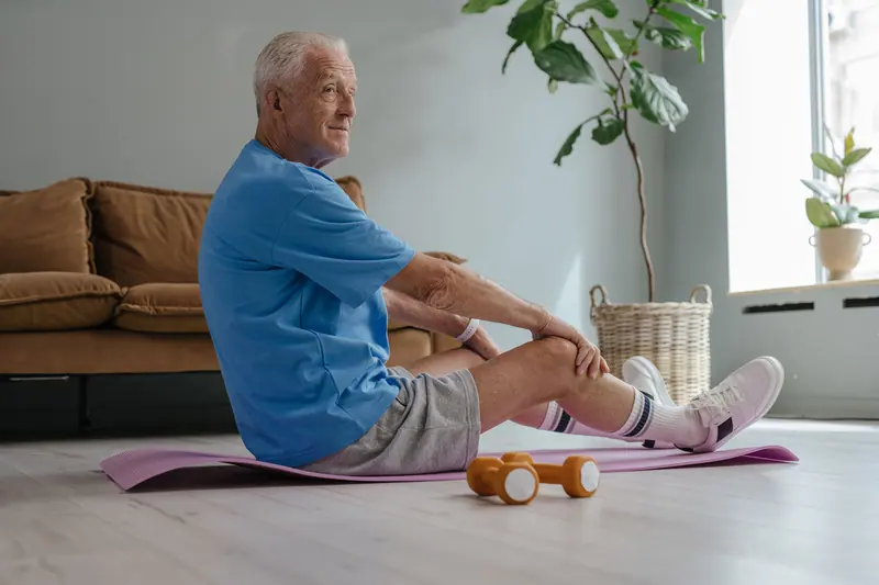 A man doing his home exercises on the living room floor