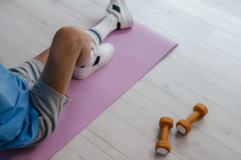A patient doing seated exercises with light dumbbells
