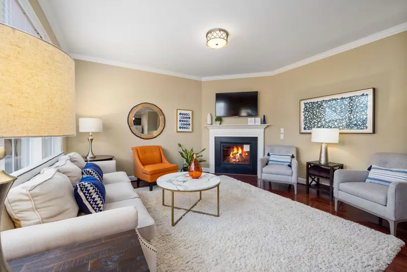 The parlor with its fireplace and soft chairs