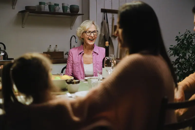 A grandmother at the head of the table