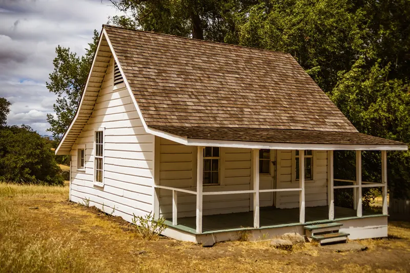 An old farmhouse in tall grass