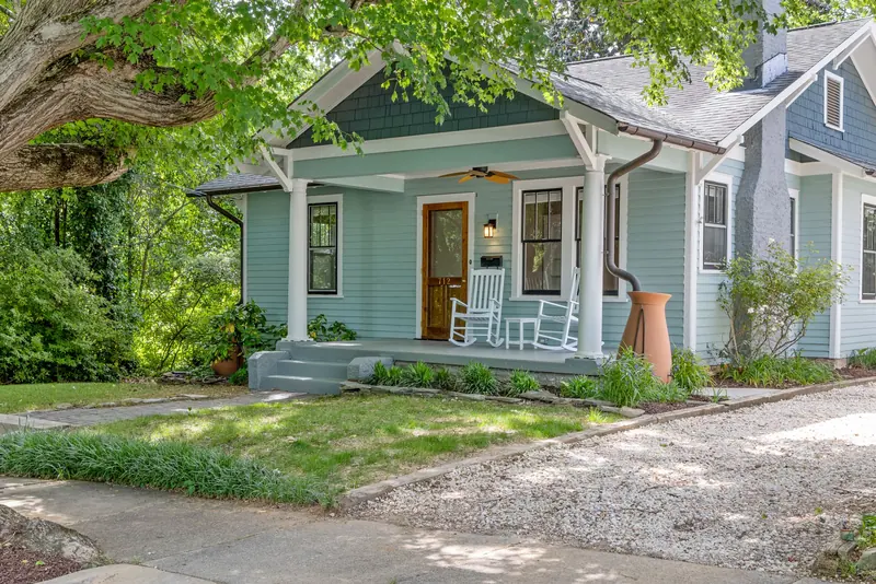 A cottage with a porch and rocking chairs